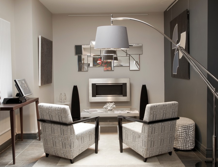 Modern living room with high-end audio speakers from Meridian Audio, stylish armchairs, and contemporary fireplace.