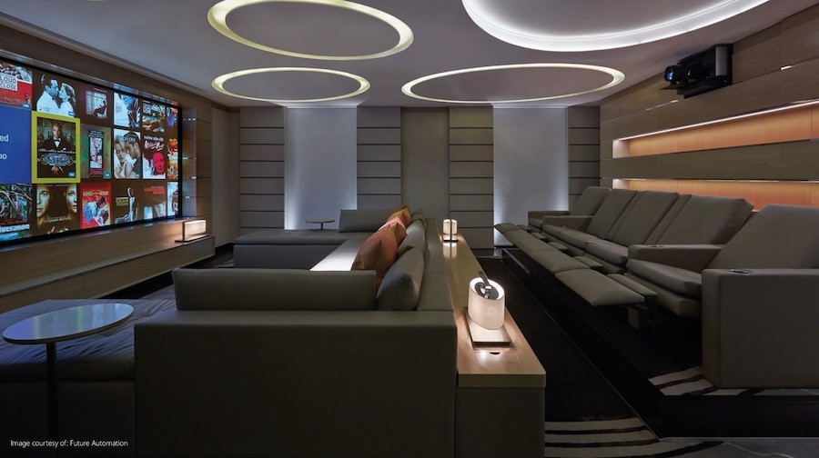 Future Automation fixed frame projector screen in a plush, immersive home theater room.